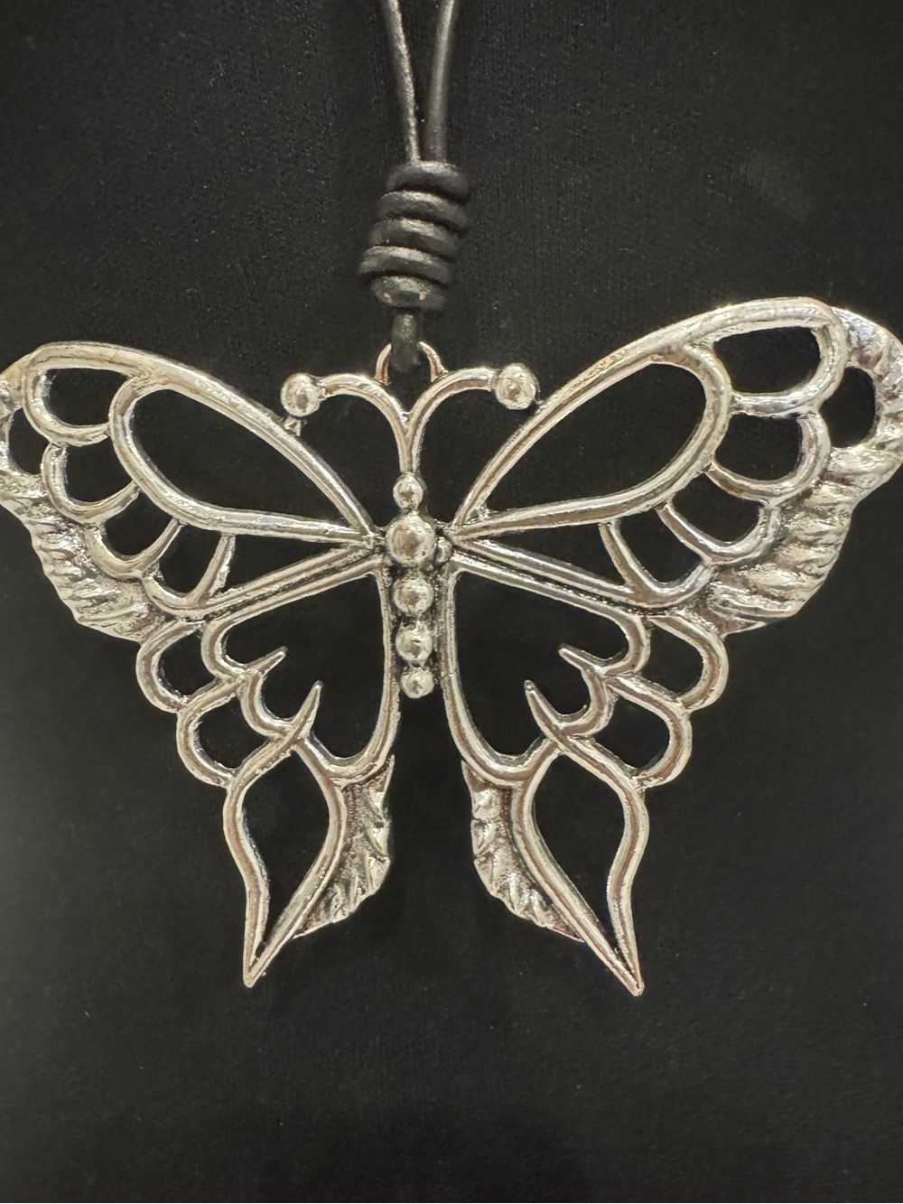 Good sized Silver tone Butterfly Pendant Necklace on 30 inch long, black cord.